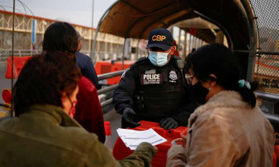 A woman shows her vaccination card to a US Customs and Border Protection agent at the Paso del Norte International Bridge on Monday.