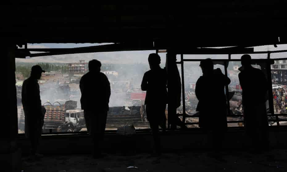 People view an explosion site in Kabul earlier in the year