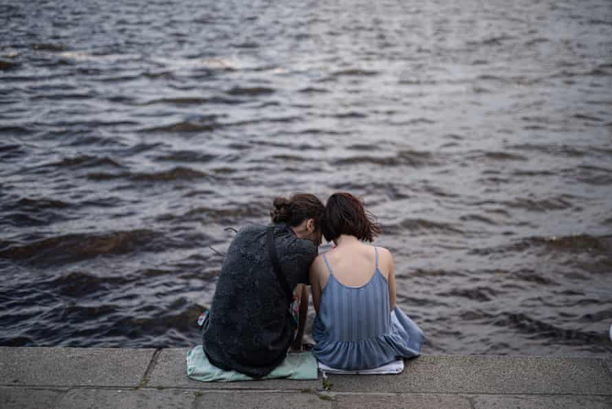 A couple sits on the Dnipro river embankment on June 12, 2022 in Kyiv, Ukraine.