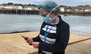 What is the test, track and trace system in England? 1 NHS worker Anni Adams looking at the contact tracing app which has been trialled on the Isle of Wight.
