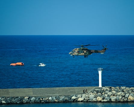 A Turkish helicopter flies low over the sea during a ferry rescue operation off Kyrenia, Cyprus