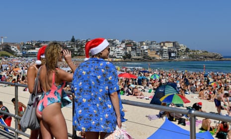 People celebrate Christmas Day at Bondi beach in Sydney on Sunday. Australia’s working holiday visa program is popular with backpackers, and only available for people 35 years and under. 