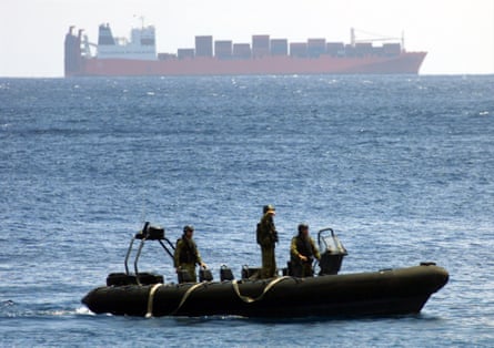 Australian SAS troops with the Tampa in the background, off Christmas Island on 30 August 2001.