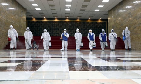 Workers from the Korea Pest Control Association spray disinfectant as part of preventive measures against the spread of the Covid-19 coronavirus, at the National Assembly in Seoul on February 25, 2020. 
