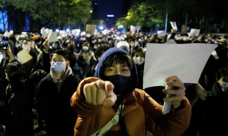 Clashes in Shanghai as protests over zero-Covid policy grip China - The Guardian 1 people hold white sheets of paper at a demonstration against Covid restrictions
