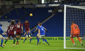 Wolverhampton Wanderers’ Moroccan midfielder Romain Saiss (C) jumps and scores the equalising goal.