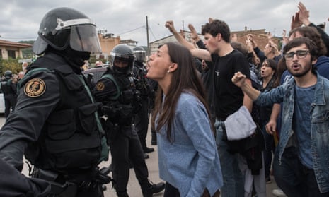 A voter in Catalonia confronts a police officer in Sant Julia de Ramis.
