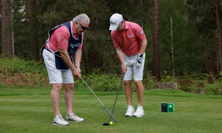 George McCluskey (left), the ex-Celtic footballer and now coach at the club, lines up the ball for his son Barry, who is partially blind
