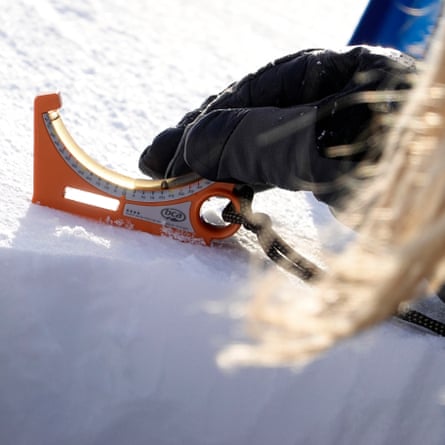 A gloved hand operates a measuring device