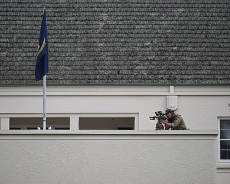 A sniper sets up position for the ceremonial welcome at Government House in Canberra