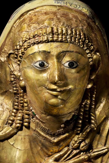 Mummy of an adult female. The head is covered by a mask of linen and plaster which has inlaid detailed eyes, and the chest has a similarly made cover with glass inlaid as jewellery. The face piece was broken but it has been restored.