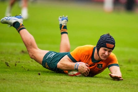 Australia’s Josh Flook scores a try against Japan