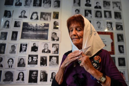 Almeida in front of pictures of disappeared