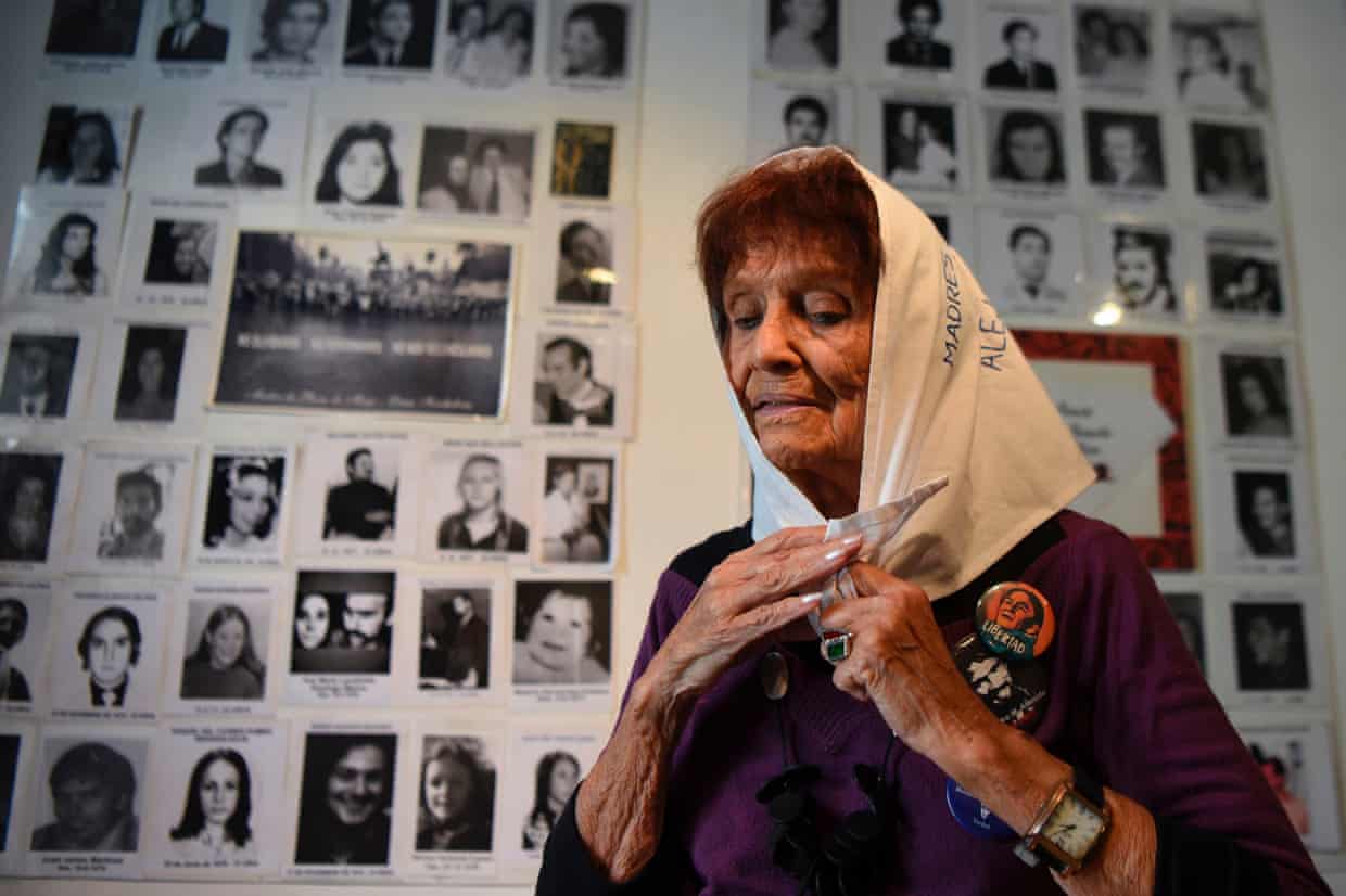 Almeida in front of pictures of disappeared