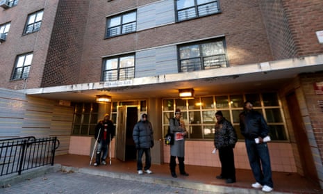 Men gather outside of the building where Akai Gurley was shot by officer Peter Liang at the Louis Pink Houses public housing complex in Brooklyn.