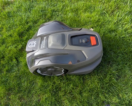 A Husqvarna lawnmower on the grass.