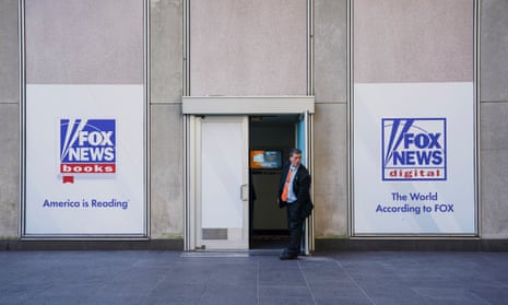 A man guards a side door to the News Corporation building in New York City on Thursday.