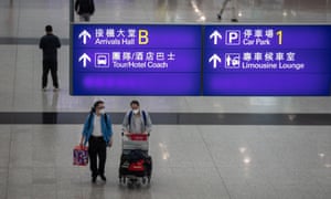 Passengers walk in the arrival hall at Hong Kong International Airport, 20 April 2021.