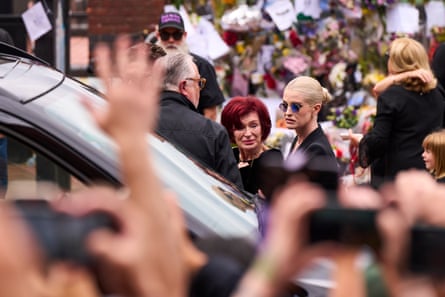 The funeral cortege halted at Black Sabbath bridge in Birmingham so his widow, Sharon, and family could see the flowers left by fans.