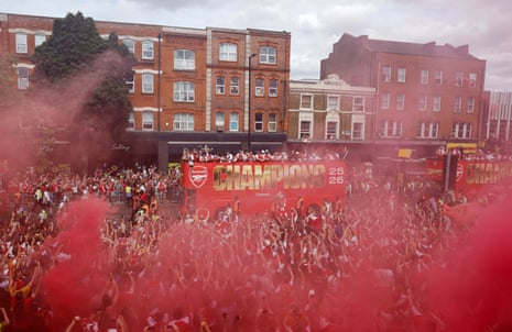 Arsenal players and fans celebrate during the parade