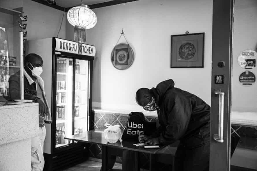 Ghost riders: the invisible lives of Johannesburg food couriers – photo essay | South Africa 14 Mande picks up an order