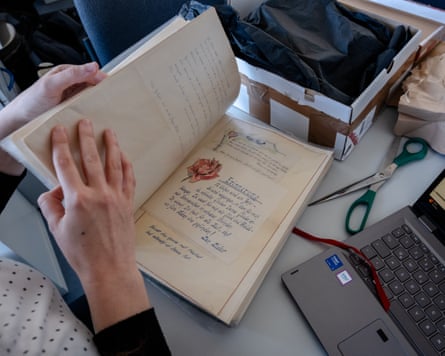 A person leafs through letters on a desk