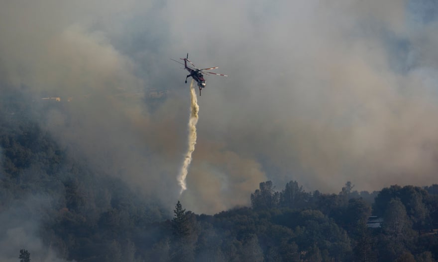 A firefighter makes a water drop near Midpines, north-east of Mariposa, California.