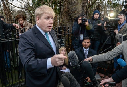 Boris Johnson speaking into press microphones.