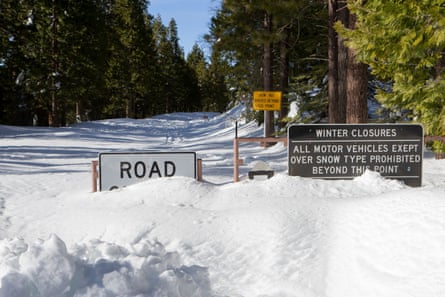 Highway 108 is closed just above Strawberry, California, with several feet of snow covering the road.