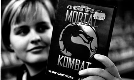 A games fan holds a copy of Mortal Combat for the Sega Mega Drive.