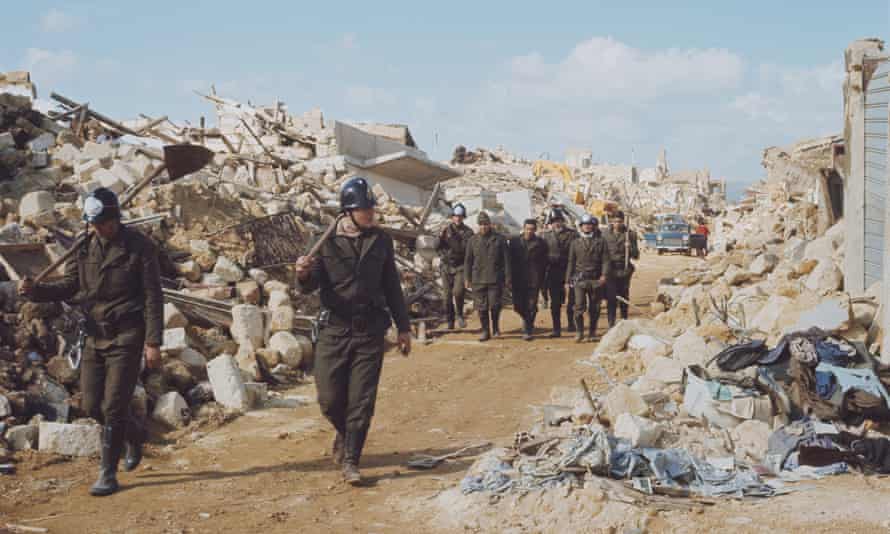 Italian firemen and rescue workers survey the ruins of Montevago, Sicily after the Belice earthquake in January 1968.