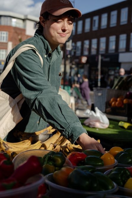 A woman shops for fruit and veg at Lewisham Market.