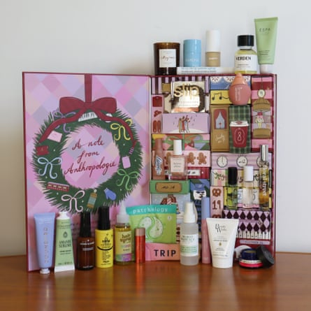 Anthropologie 24 Days of Beauty Advent calendar open on a table, with its beauty products arranged alongside it