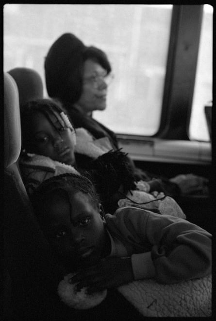black and white photo of children and woman on bus