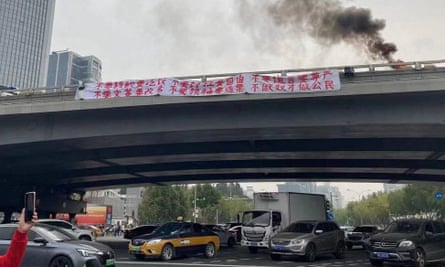 Rare political protest banners removed in Chinese capitalSmoke rises as a banner with a protest message hangs off Sitong Bridge, Beijing, China October 13, 2022 in this image obtained by REUTERS ATTENTION EDITORS - THIS IMAGE HAS BEEN SUPPLIED BY A THIRD PARTY. NO RESALES. NO ARCHIVES. SUBJECT’S FACE OBSCURED AT SOURCE.