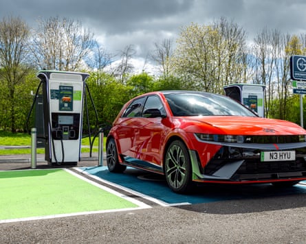 An orange Hyundai Ioniq 5 N parked at an EV charging point