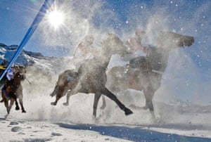 St Moritz , Switzerland: Contestants at the White Turf horse race on the frozen lake of the Swiss mountain resort