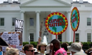 Protesters carry signs during the Peoples Climate March at the White House in Washington.