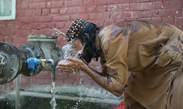 A man throws water on his face to cool off in Islamabad, Pakistan