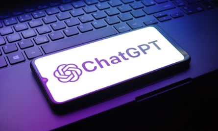 ChatGPT logo on a smartphone next to a computer keyboard