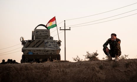 A Peshmerga rests on the side of the Hawler - Kirkuk road after his unit fled Kirkuk, following a military operation by the Iraqi Army and Hashd al-Shaabi units to retake the city of Kirkuk.