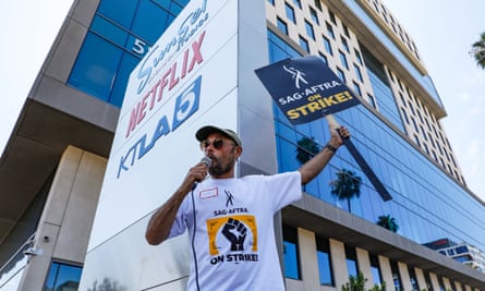 A striking actor outside Netflix’s Los Angeles office