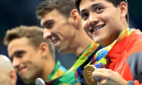 Joseph Schooling poses with his gold medal after winning the men’s 100m butterfly final.
