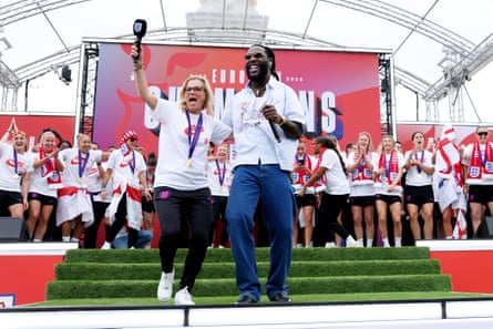 Burna Boy performs on stage alongside Sarina Wiegman, head coach of England, during the football team’s victory parade