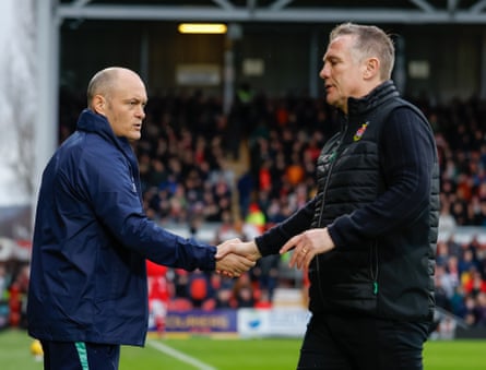 Millwall manager Alex Neil (left) and Wrexham’s Phil Parkinson shake hands before the match.