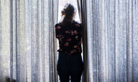 File photo of woman looking outside the window
