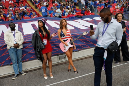 Paige Blake (centre) prepares to play the American national anthem on her electric guitar.