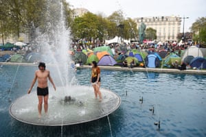 People enjoy the fountains at the Extinction Rebellion camp in Marble Arch