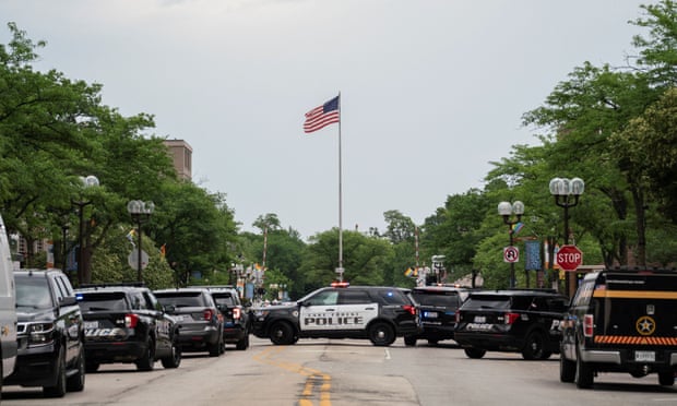 Officers monitor the scene of a shooting at a Fourth of July parade in Highland Park, Illinois. 