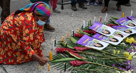 A member of the Civic Council of Popular and Indigenous Organizations of Honduras (Copinh) lights a candle after the verdict.